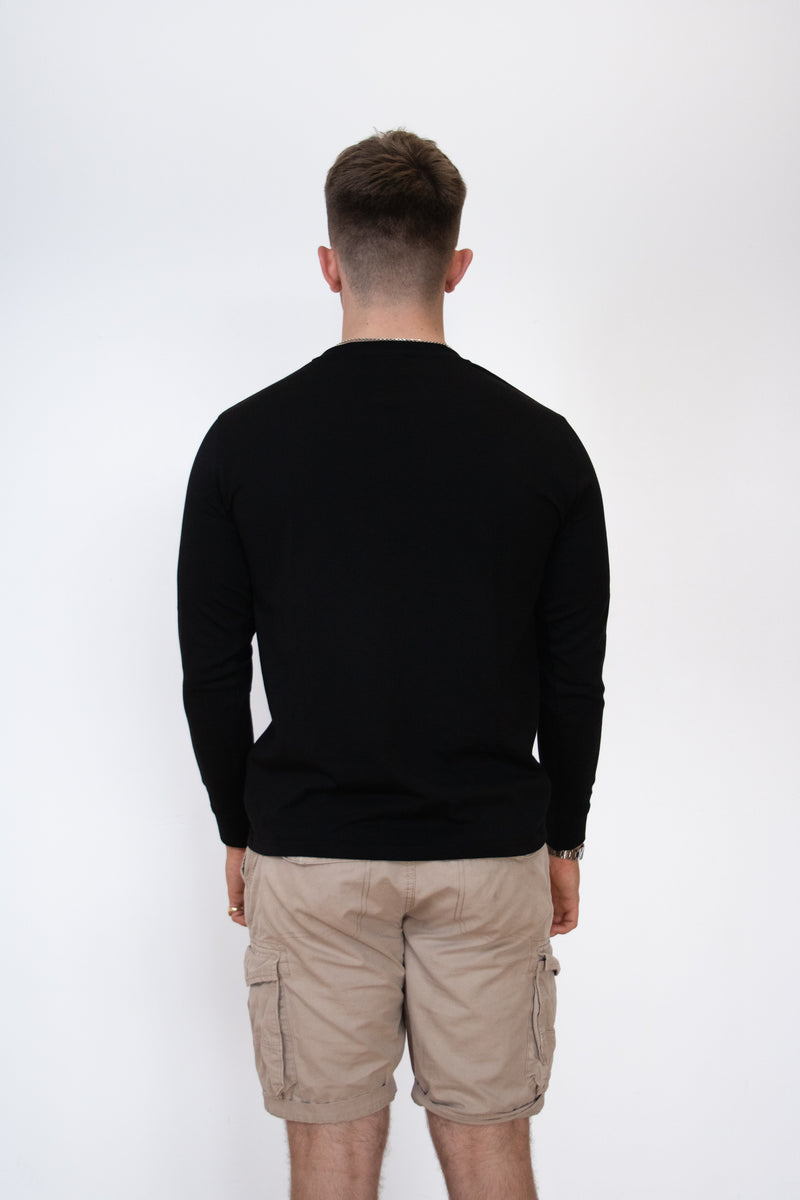 Back view of a male model wearing a black long sleeve cosycore tshirt by beCosy with an embroidered cat logo