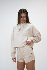 Front view of female model showing of the cosycore cream terry shorts from beCosy matched with the cosycore cropped hoodie