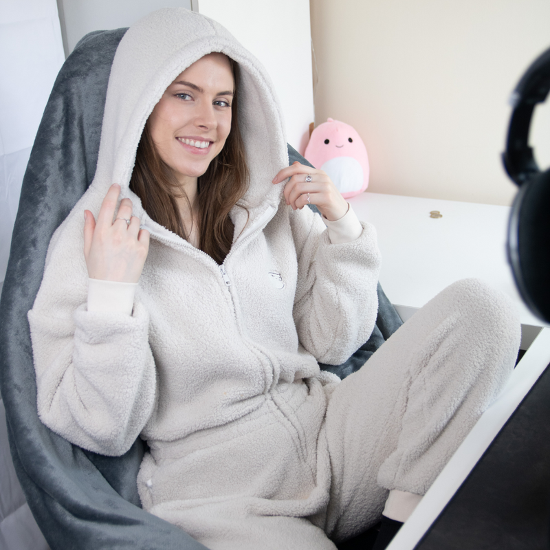 model sat in gaming set up wearing becosy stone coloured ultimate sherpa onesie